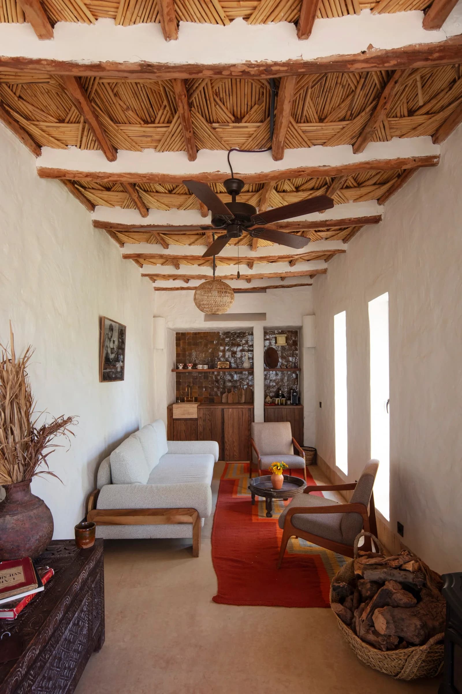 The Private Cottage salon under a traditional tatawi ceiling of wood and reed